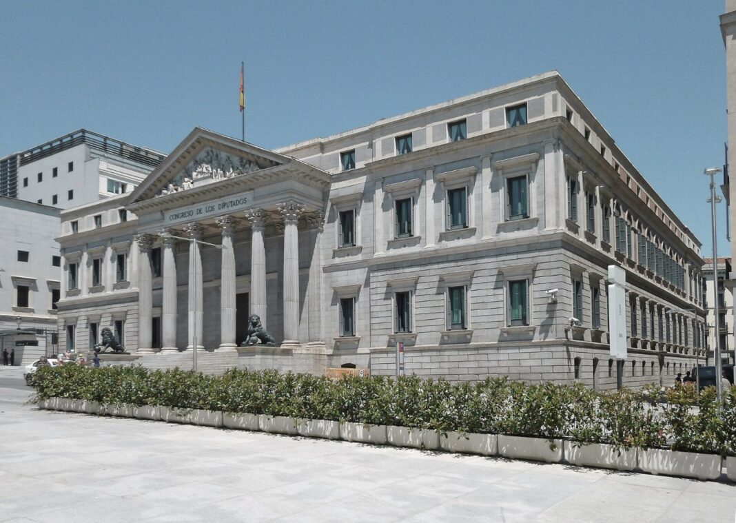 While Europe bolts its doors, Spain hands out papers